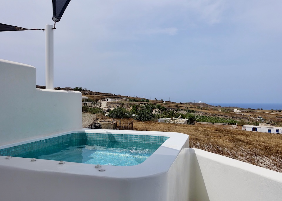 A private jacuzzi facing west over some farms and vineyards toward the sea at Myst Boutique Hotel near Oia, Santorini.