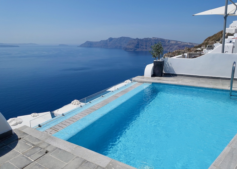 A private pool above the caldera with Thirassia Island in the background at Santorini Secret in Oia, Santorini.