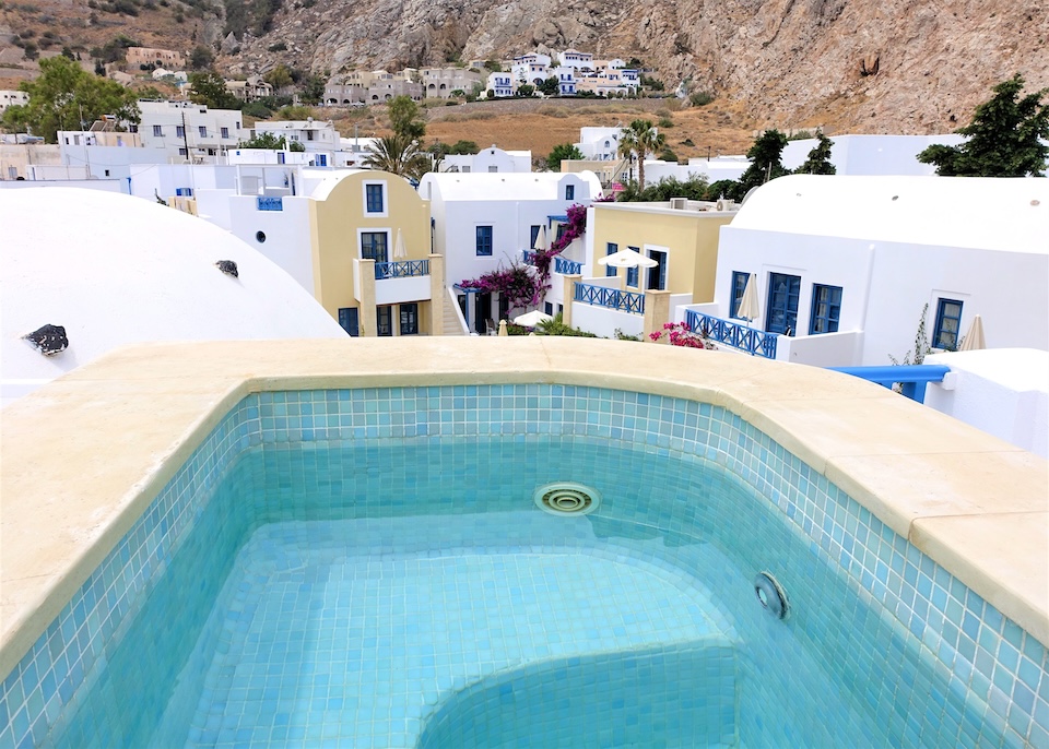 A private jacuzzi on a rooftop facing the interior courtyard of the hotel at Tamarix del Mar in Kamari, Santorini.