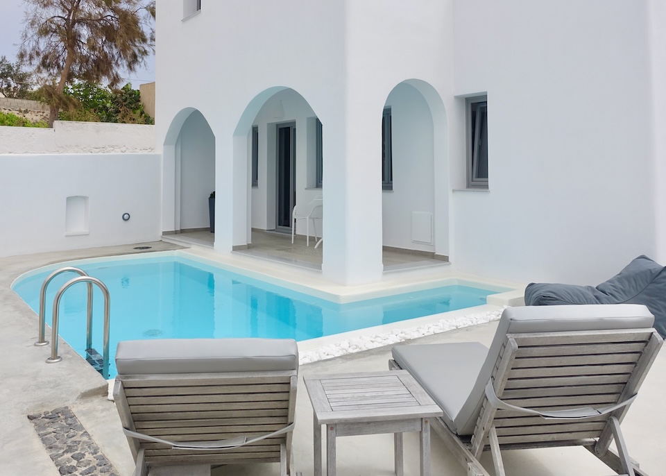 Sunbeds in front of a suite's private pool at White Harmony Suites in Megalochori, Santorini.