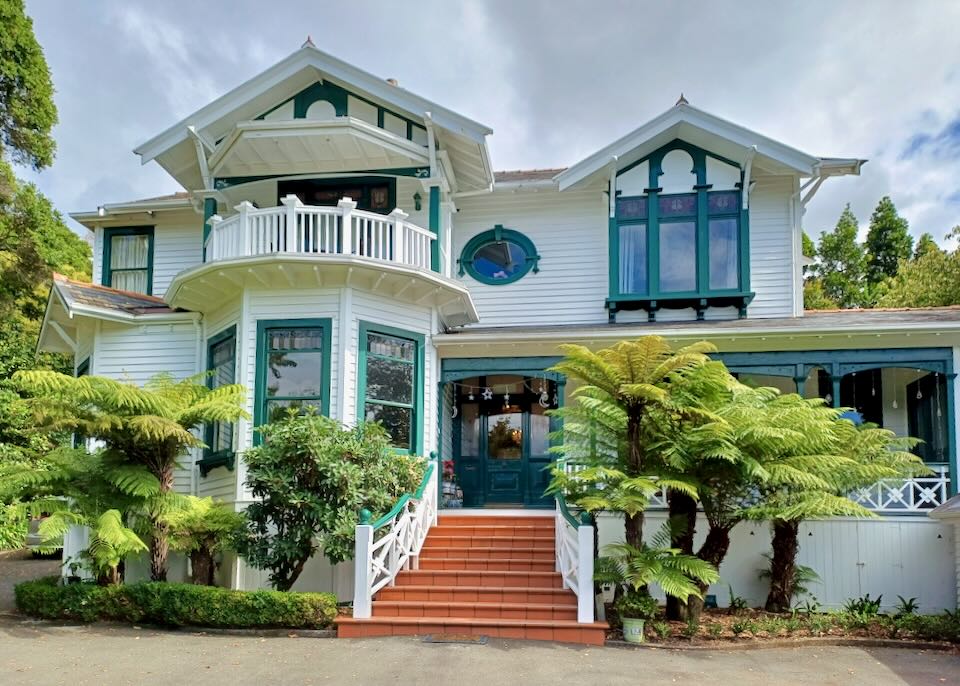 A house with green painted trim and orange steps.