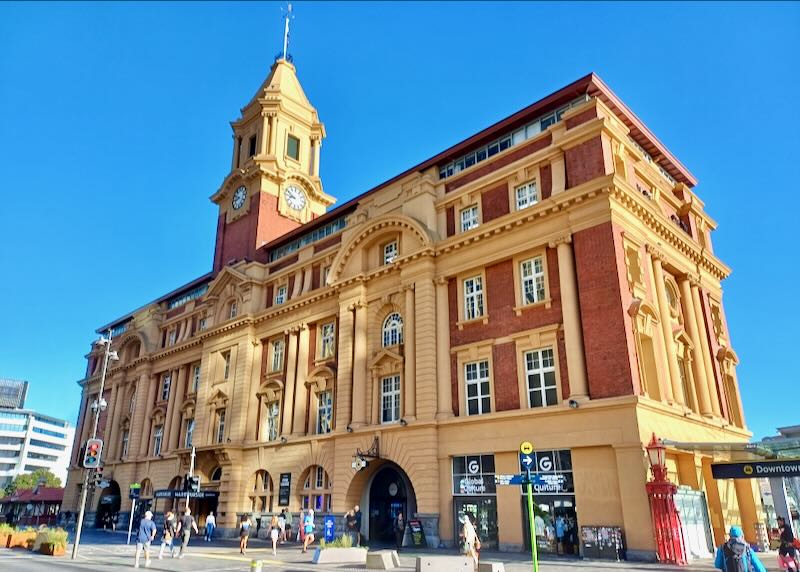 A tall 4-story brick building with a clock tower.