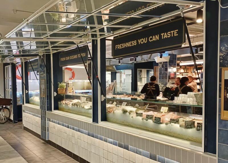 A fish counter with ice and fresh seafood.