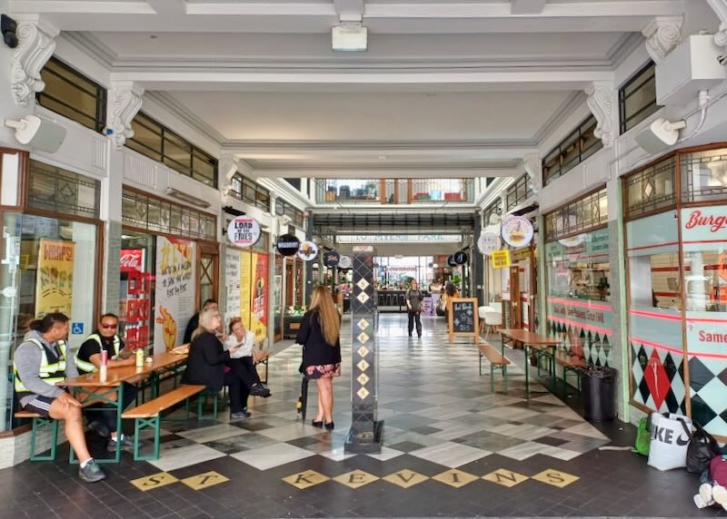 colorful shops sit in and old building.