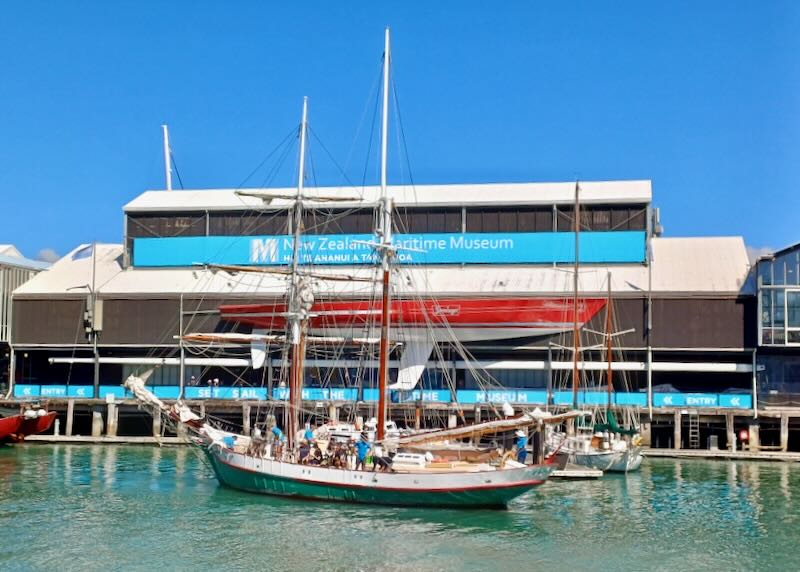 An old sailboat floats in the harbor.