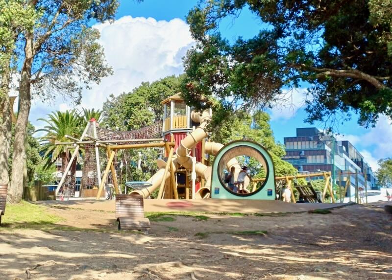 Kids play on playground equipment.