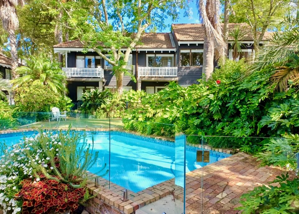 A green garden with a pool.