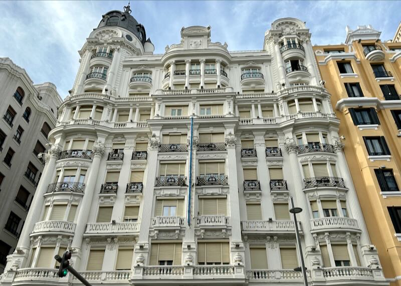 View looking up at an ornately decorated apartment building in Madrid