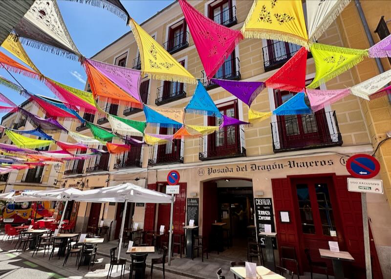 Small Spanish hotel with colorful flags flying in front