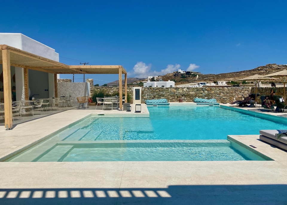 Steps lead down into an infinity pool at its attached jacuzzi at Koukoumi Vegan Hotel in Ano Mera, Mykonos.