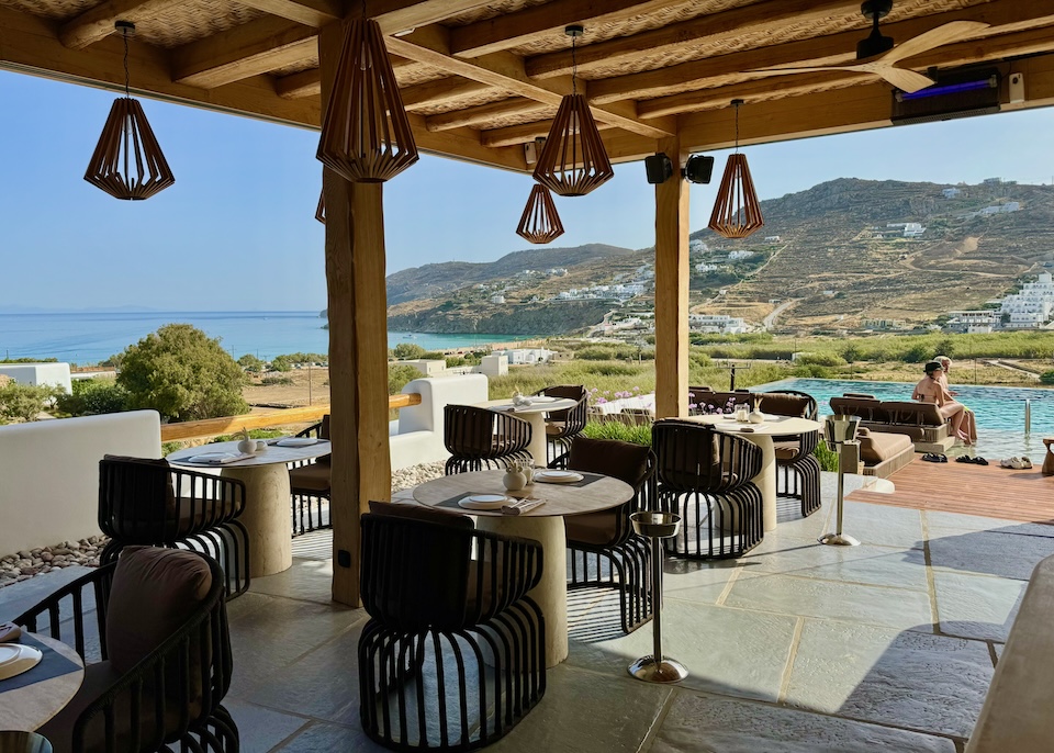 A bohemian-chic restaurant next to an infinity pool at Mileo hotel in Kalo Livadi, Mykonos.