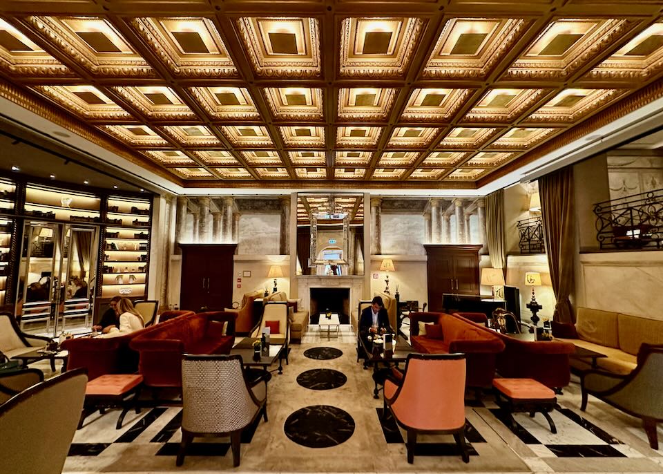 Hotel Lobby with striking geometric ceiling boxwork and modern furnishing. 