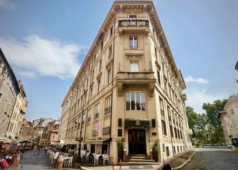 Corner view of a flat-iron shaped hotel building in Rome