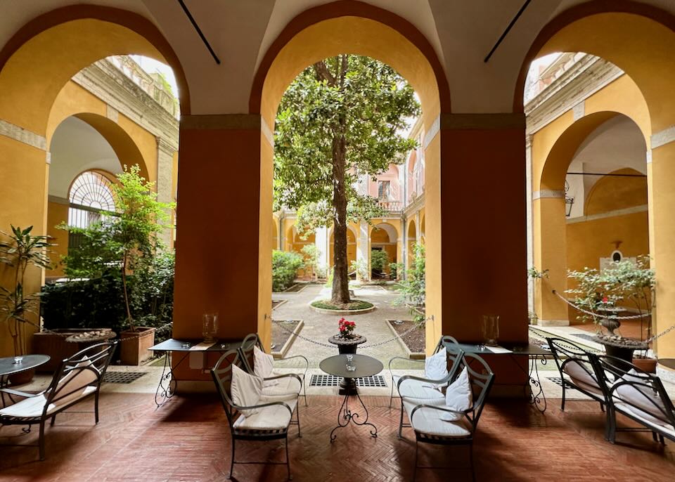 Hotel garden courtyard with an arched colonnade.