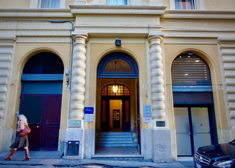 Doorway of a Roman hotel building with stone pillars in front