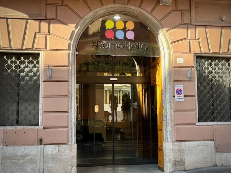 Arched stone doorway of a small hotel on a Roman street