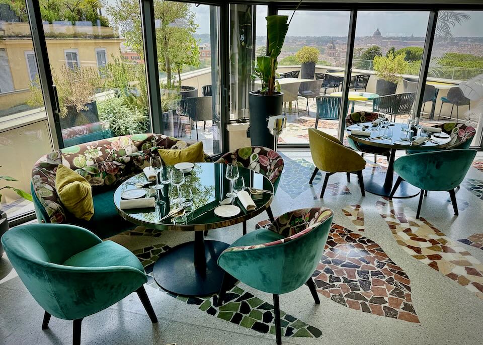 Chic dining room with terrazzo floors and a balcony with views over Rome