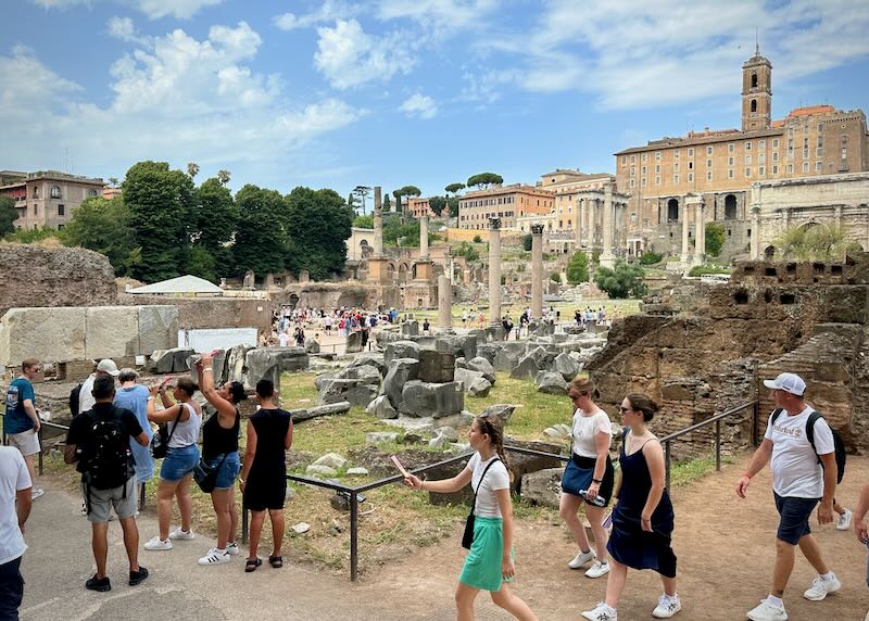 Tourists take photos and sightsee at the Roman Forum