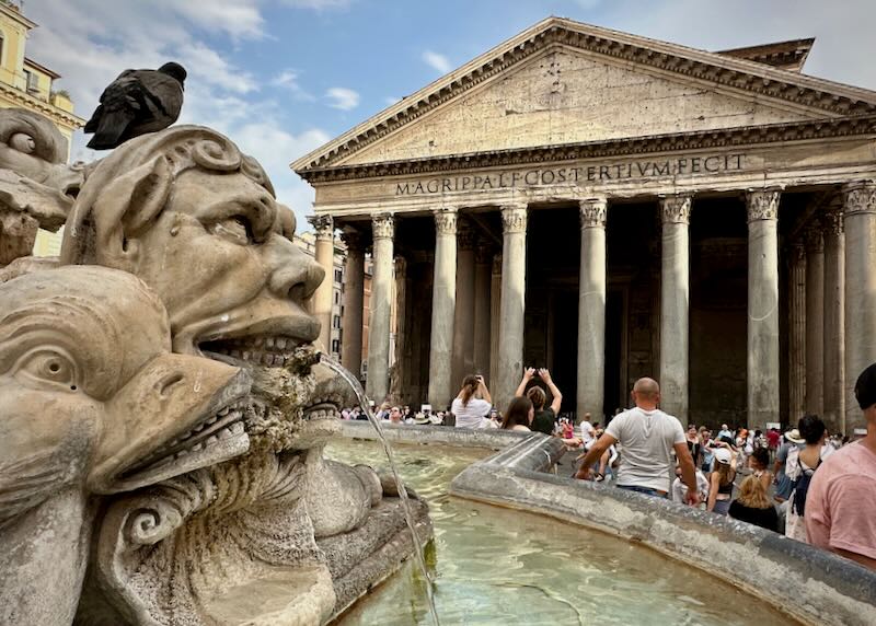 View of the Pantheon in Rome, with the figure of a fountain head in the foreground.