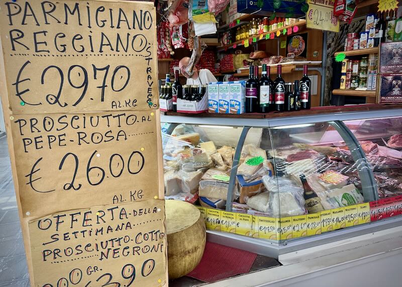 Signboard with prices on display at an Italian market