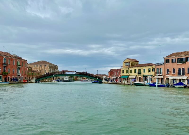 Wide canal with colorful houses and buildings on either side