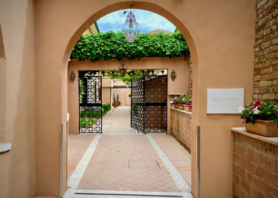 View looking in an arched entryway to a luxury hotel in Italy