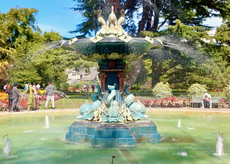 A fountain with fish and bird sculptures.