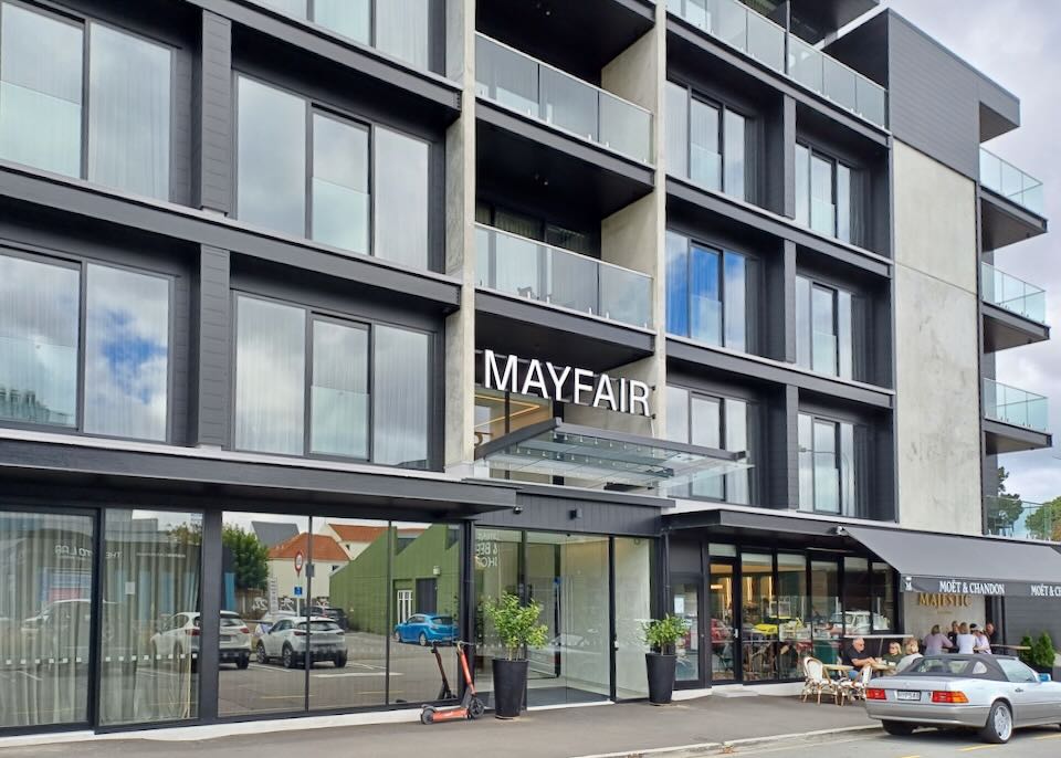 A 5-story hotel with a sign that reads, "Mayfair."