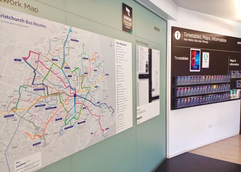 A wall map with bus routes and map brochures.