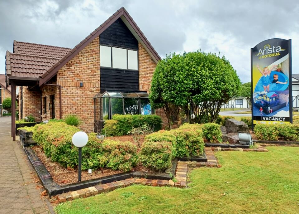 An orange brick building with matching brick landscaping.