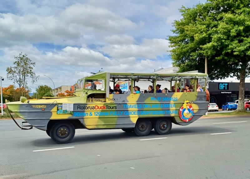 Passengers ride on a duck boats.