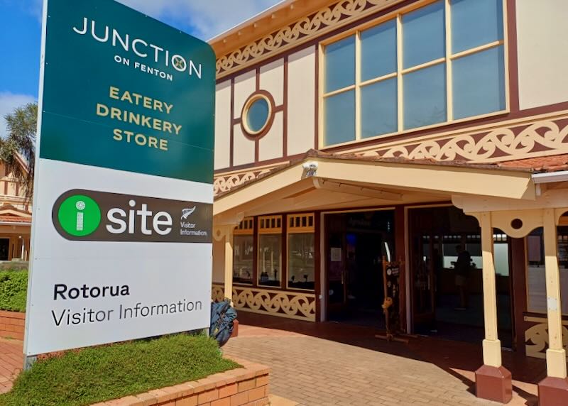 A large Visitor Information sign stands outside and office.