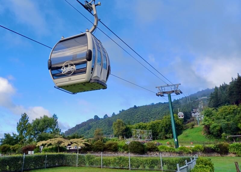 A cable car hangs on a cable.