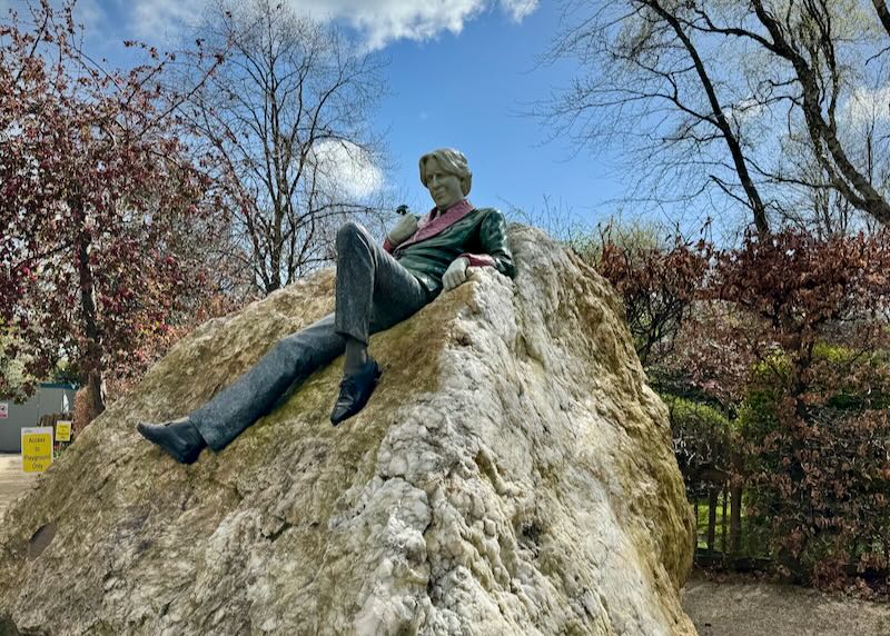 Statue of Oscar Wilde, lounging on a rock in Merrion Square park