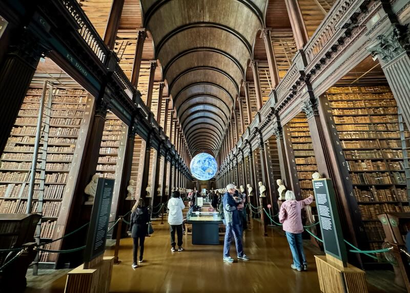 Large double-floored library with woodwork extending through the arched ceiling