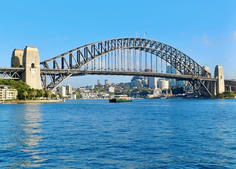 An arched bridge holds the weight of the road that crossed the water.