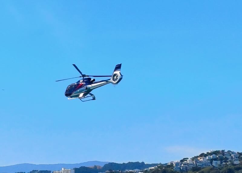 A helicopter flies through the air.