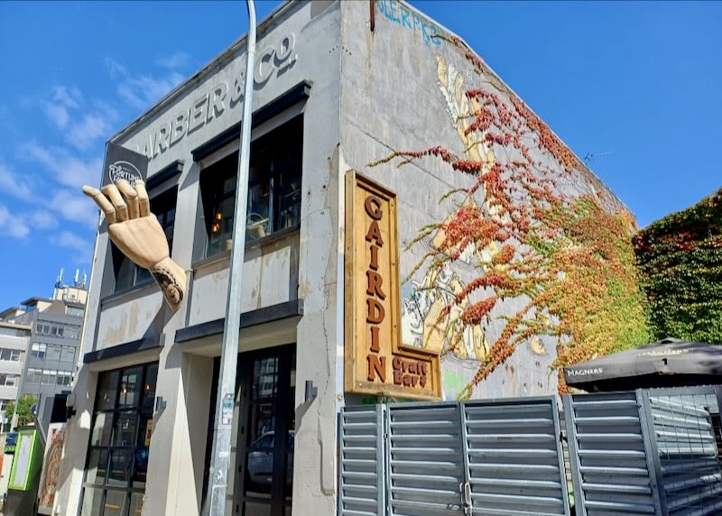 A cement building with a large hand.