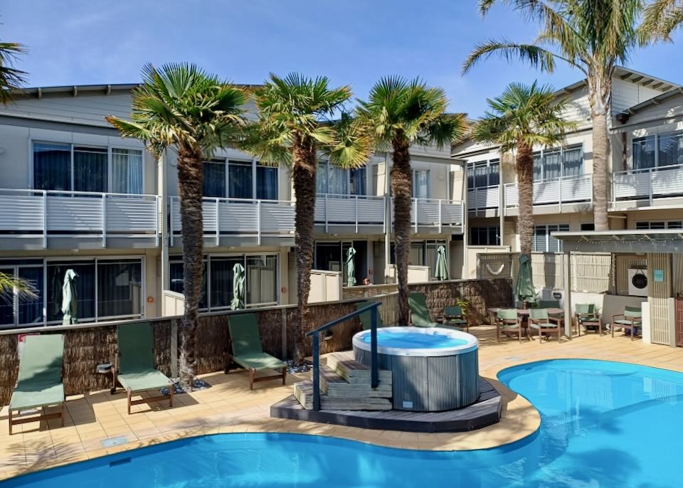 A pool sits in the center of a hotel.