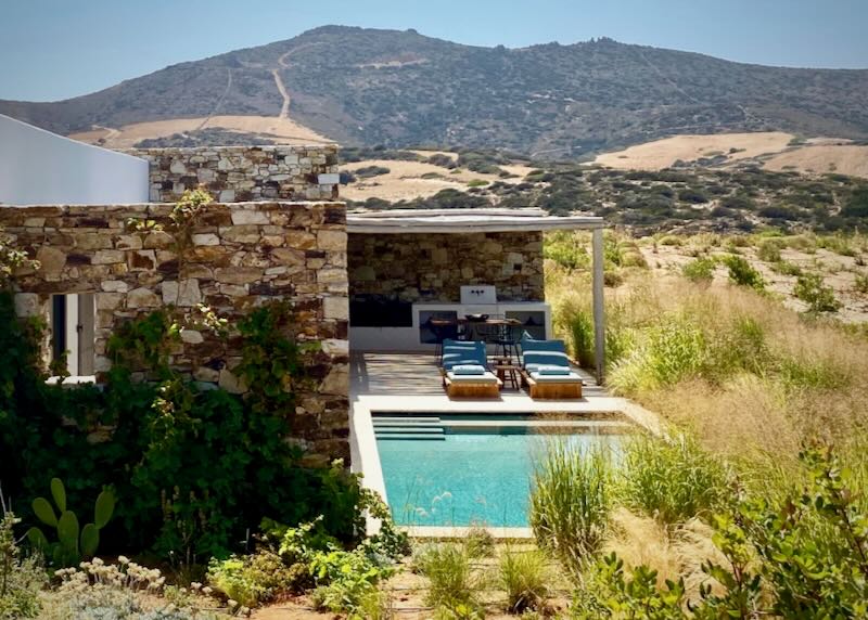 View from above of a luxury stone villa with a private pool.