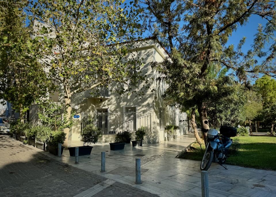 View of a small hotel in a converted neoclassical townhouse .on a shady street