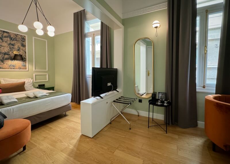 Hotel room with art deco details and sage green walls