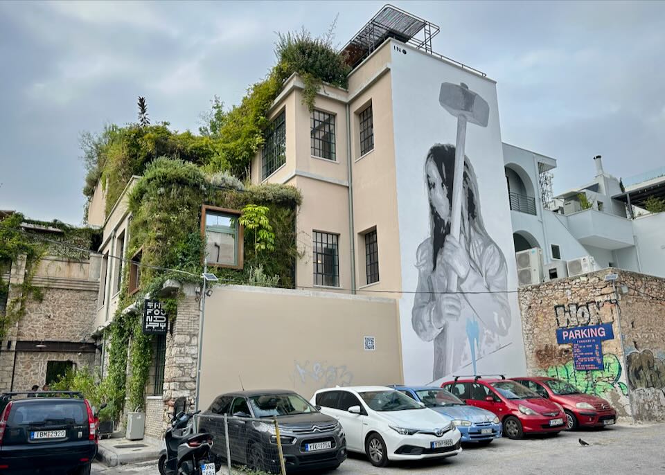 Side view of a hotel covered with vines and murals