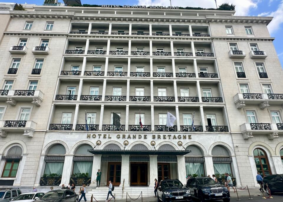 View looking up at the opulent white exterior of the Grand Bretagne hotel in Athens