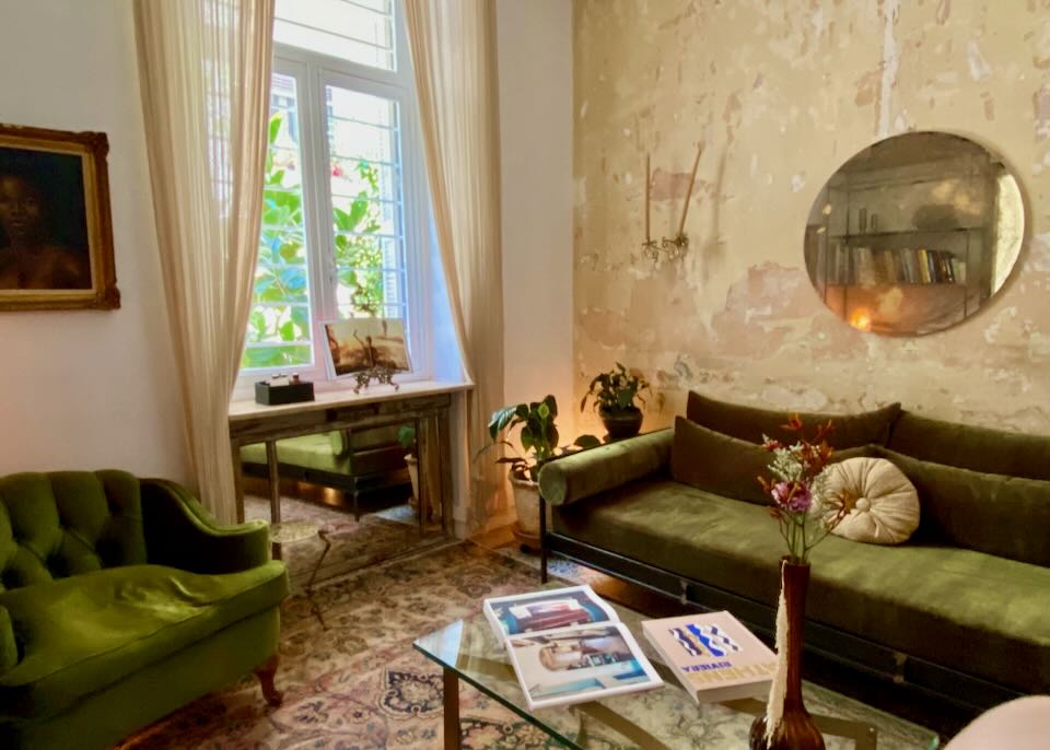 Hotel sitting room with distressed walls and velvet furnishings