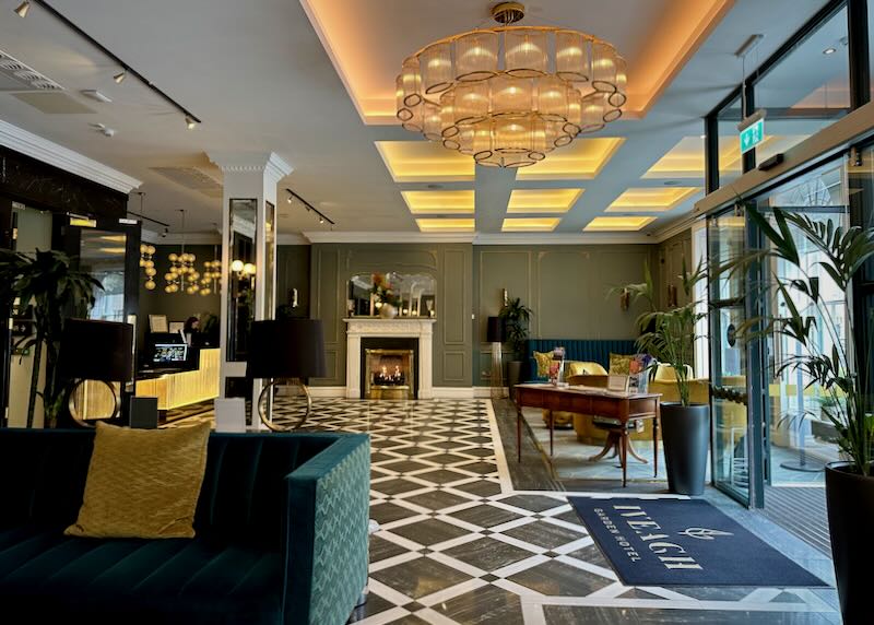 Hotel lobby with elegant modern furnishings and a fireplace.