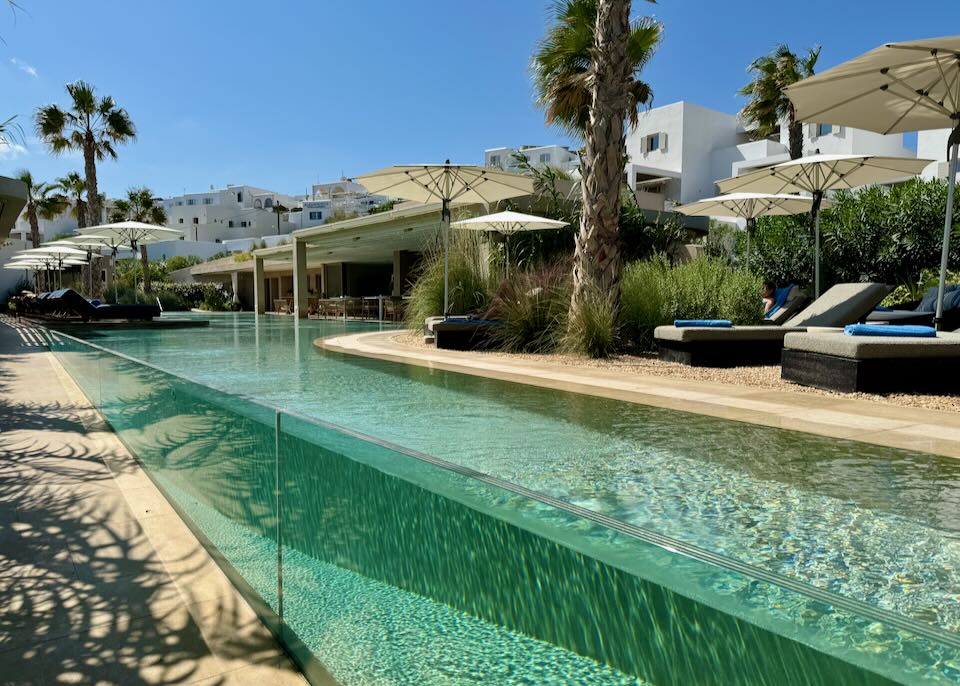 Glass-front swimming pool leading to the sea.