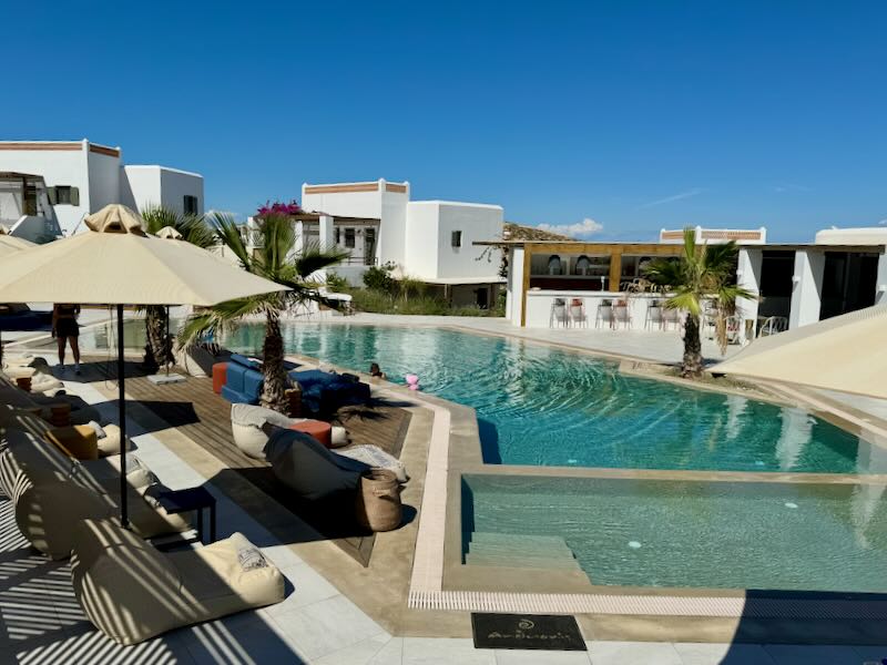 A woman tends to a child at a luxury hotel swimming pool.