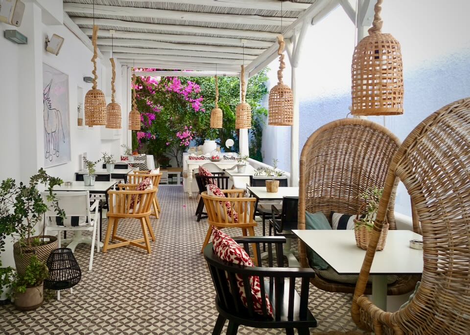 Covered outdoor breakfast area of a small Greek hotel.