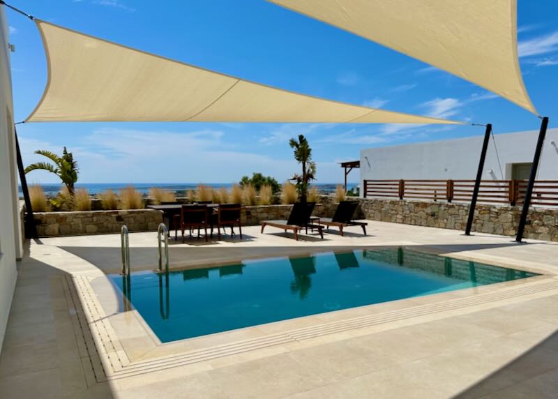 Private hotel swimming pool shaded by sun-sails